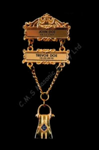 Gold Masonic jewel with name plates attached.